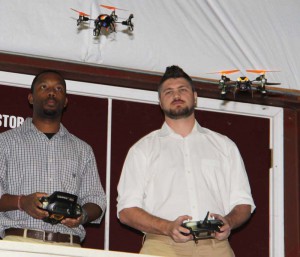 David Young of Jackson, left, and Brett Wheat of Clinton demonstrated their skills with UAV flying during the signing ceremony.