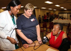 Hinds student Adesola Adefusia of Jackson watches as Elinda Hagan, Health Care Assistant Program instructor, checks the blood pressure of Joyce Adams, life skills instructor at Jackson Campus-Nursing Allied Health Center.