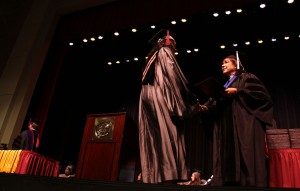 Vice President of Raymond and Jackson Campus-Nursing/Allied Health Center Theresa Hamilton gives out diplomas during the Hinds Community College Summer Commencement Ceremonies.