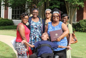 Surrounded by members of her family, Kim Brookins of Jackson shows off the degree in office systems from Hinds Community College on May 15. Brookins, 45, said she is the first person in her family to graduate from college. “In order to increase my career opportunities, I needed a degree,” she said.