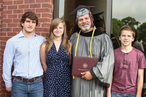  Tracy Duncan of Florence graduated with an associate degree in auto body repair on May 15 at Hinds Community College. With him are his children, from left, Aiden, Laura and Ben. Duncan is the sports marketer/photographer at Hinds. 