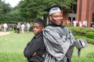 James Davis of Jackson celebrates graduating from Hinds Community College on May 15 with his nephew and adopted son, Jarontae Craft. Davis plans to major in social work at Jackson State University.