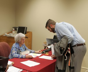 Hinds Community College Admission employee Ann Travis checks in Nathan Goss of Brandon. He graduated from Hinds Community College on May 14 with an Associate Degree in Nursing.