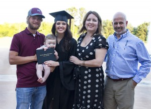 Madison Nance, center left, holds her son, Cooper, while Cooper holds his mother’s high school diploma following the Gateway to College graduation ceremony Thursday at the Muse Center on the Rankin Campus. Also pictured, from left, his father, Dillion Cooper, Jana Nance and Ken Nance.  