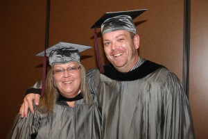 Angela Wilson, left, and Michael Thompson, right, enjoy a light moment before Thursday's afternoon's graduation ceremony at the Muse Center on the Rankin Campus. Hinds Community College conferred 443 degrees and certificates to 304 graduates for this summer's ceremonies