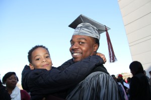Keren Garrett gets a hug from his nephew, Brayden, following graduation ceremonies at the Muse Center on Hinds Community College's Rankin Campus. Garrett earned an Associate of Applied Science degree in Landscape Management Technology. (April Garon/Hinds Community College)