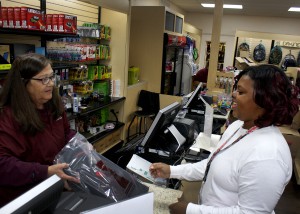 Keyetha McGee, right, of Terry, a first-year student at Hinds Community College, purchases a headphone set from campus bookstore employee Mollie Lee on the Raymond Campus Monday, Jan. 11, 2016. Monday was the first day of classes for the spring 2016 semester. (Tammi Bowles/Hinds Community College)