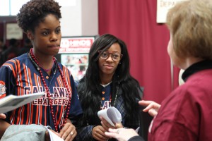 Jazmine Hathorn, left, and Tamera Lofton, center, get information on Hinds' 2+2 Program in Elementary Education with Delta State University with the program's Terry Parrish, right, at Eagle Experience 2016 at Mayo Gym on the Raymond Campus Feb. 5, 2016 (April Garon/Hinds Community College)