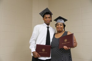DeMarcus Grear, left, enjoys a happy moment with Vonya Grear, his mother, following a graduation ceremony at Hinds Community College Utica Campus on May 15, 2016. DeMarcus received a career certificate in Automotive Technology, while Vonya received an Associate in Arts in Clothing and Fashion Technology. (April Garon/Hinds Community College)