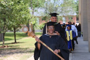 Gwendolyn Strong, admissions processor at the Utica Campus, led graduates as the Mace Carrier for the Hinds Community College Utica Campus graduation ceremony May 15, 2016. (April Garon/Hinds Community College)