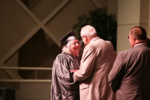 Susan Brown, left, accepts her GED certificate from Hinds Community College President Dr. Clyde Muse during a ceremony at Cain-Cochran Hall on the college's Raymond Campus on June 23, 2016. (April Garon/Hinds Community College)