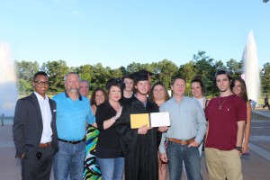 Raymond Flowers III, center, in cap and gown, earned three college credit hours by earning his high school diploma from Northwest Rankin High School through the Gateway to College Program at Hinds Community College's Rankin Campus. Front row, from left, Allysyn Jones, a friend; Derek McIntyre, his stepfather; Tanya McIntyre, his mother; Flowers; Raymond Flowers II, his father; Dalton Ferguson, a friend; back row, from left, Chandler Coker, a friend; Tabitha Sims, his stepmother; Dylan Sims, a friend; Allie Crowley, a friend; Shelby Sims, a friend; and Claire Allen, his girlfriend. (April Garon/Hinds Community College)