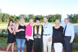 Janie Kovach, center, in cap and gown, earned 24 college credit hours after earning her diploma from Northwest Rankin High School through the Gateway to College Program at Hinds Community College's Rankin Campus. From left, Megan Ashmore, her cousin; Jameson Cardullo, her second cousin; Jordan Kovach, her sister; Janie Kovach, her mother; James Kovach, her father; Margaret Kovach, her grandmother; James Kovach Sr., her grandfather. (Apri Garon/Hinds Community College)