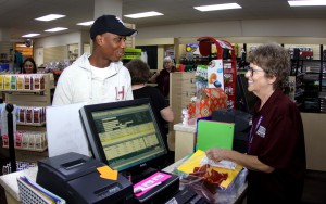 Blair McIntosh, left, of Jackson, checks out some notebooks at the Raymond Campus bookstore on the first day of the Fall 2016 semester at Hinds Community College. Behind the counter is Susan Anthony. (Tammi Bowles/Hinds Community College)