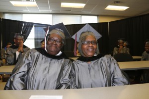 Barbara Evans, left, and Lattie Erving, share a moment before graduation ceremonies May 12 at the Muse Center at Hinds Community College Rankin Campus. Evans, of Vicksburg, and Erving, of Jackson, both returned to school to earn college degrees after having been retired for years. (Hinds Community College/April Garon)