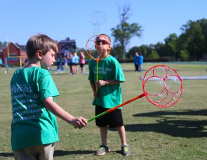 Raymond Elementary students Danny Russom, 7, left, and Ely Ashley, 9, have a grand time with the bubbles at the May 2 special education field day held at Hinds Community College. (Hinds Community College/April Garon)
