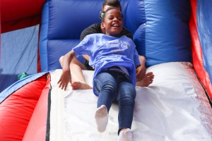 Gary Road Intermediate student Mason Clark, 9, slides down the bouncy house slide. He was at the “Let Your Light Shine On” field day for Hinds County special education students on May 2 at Hinds Community College. (Hinds Community College/April Garon)