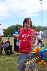 Terry High student Clive Cargill pulls out a stick to see how many balls will fall in the “Let Your Light Shine On” field day for Hinds County special education students on May 2 at Hinds Community College. (Hinds Community College/April Garon)