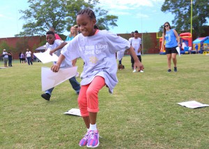 Bolton Elementary student Trevae Green, 8, foreground, and Kendarius Thomas, 10, race during a matching game at the “Let Your Light Shine On” field day for Hinds County special education students on May 2 at Hinds Community College. (Hinds Community College/April Garon)