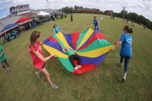 Raymond Elementary student Breanne Uzzle, 8, loves being spun around on the parachute at the “Let Your Light Shine On” field day for Hinds County special education students on May 2 at Hinds Community College. (Hinds Community College/April Garon)
