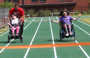 Byram assistant principal Tommy Burchfield and Elina Smith, left, gave Mollie Coward and student mentor Jared Keyes a run for their month but once again Mollie won the annual wheelchair race at the “Let Your Light Shine On” field day for Hinds County special education students on May 2 at Hinds Community College. (Hinds Community College/April Garon)