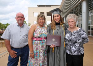 Annabeth Bowman, center-right, of Pelahatchie, was among 464 students who received credentials from Hinds Community College during summer graduation ceremonies July 28 at the Muse Center on the Rankin Campus. She earned an Associate of Arts degree in General Studies and plans to pursue a nursing degree. With her, from left, are her father Dewayne, her mother Ann, and aunt, Margie Warren. (Hinds Community College/April Garon)