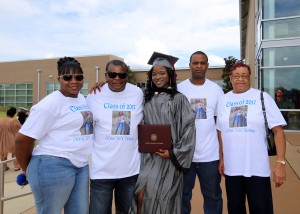 Jataria Claiborne, center, of Port Gibson, was among 464 students who received credentials from Hinds Community College during summer graduation ceremonies July 28 at the Muse Center on the Rankin Campus. She earned an Associate of Applied Science degree after completing the Business Management and Finance program. Family members had t-shirts printed for the occasion. (Hinds Community College/April Garon)