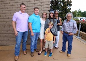 Tes Seymour, center, of Vicksburg, was among 464 students who received credentials from Hinds Community College during summer graduation ceremonies July 28 at the Muse Center on the Rankin Campus. She earned an Associate of Applied Science degree in Emergency Medical Sciences. With her, from left, are husband John Seymour, Caleb Anthony, Madisyn Anthony, her mother Terry Saldana and father Joe Saldana. (Hinds Community College/April Garon)