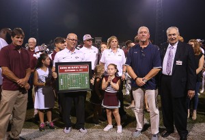The Hinds Community College football field was named Gene Murphy Field in honor of the coach who stepped aside as head coach last month. At the Sept. 14 halftime ceremony were, from left, Rick Trusty, president of Hinds Athletic Alumni Association chapter; Murphy holding the photography; his wife Dot Murphy; Jim Southward, director of Athletic Activities for the Mississippi Community College Board and Hinds President Dr. Clyde Muse. The announcement was made as Murphy was surrounded by his children and grandchildren, also pictured.